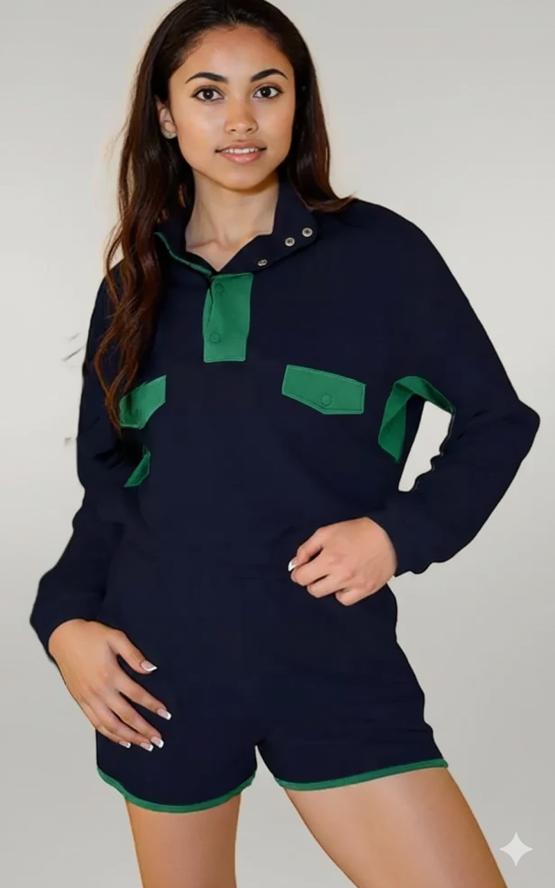 Person wearing a navy blue outfit with green accents on a plain background