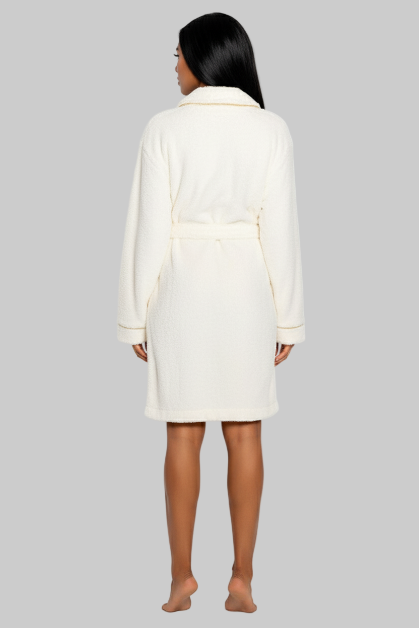 Person wearing a white coat against a white background