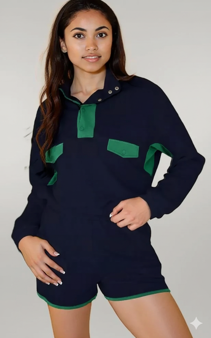 Person wearing a navy blue outfit with green accents on a plain background