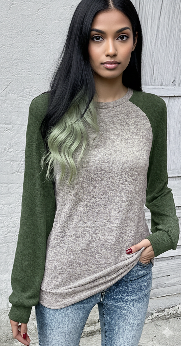 Woman wearing a gray and green long-sleeve shirt against a light gray background